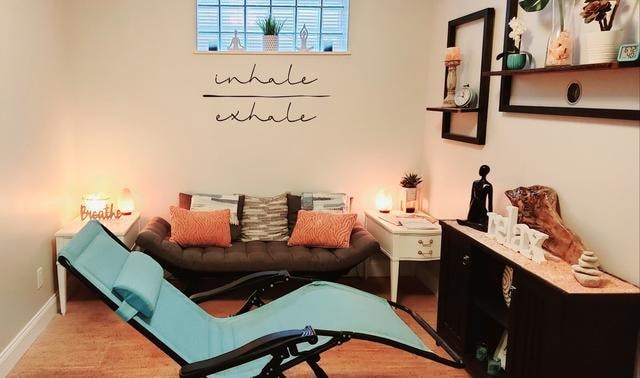 Relaxing salt therapy room with recliner chair, couch, and ambient lighting