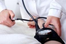 Medical professional taking a patient's blood pressure